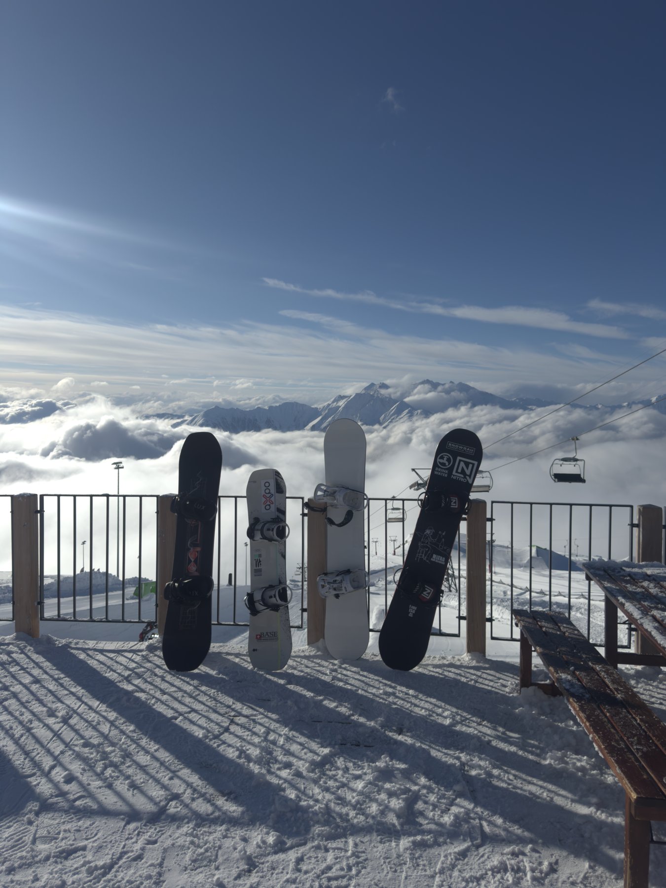 Snowboards above a sea of clouds